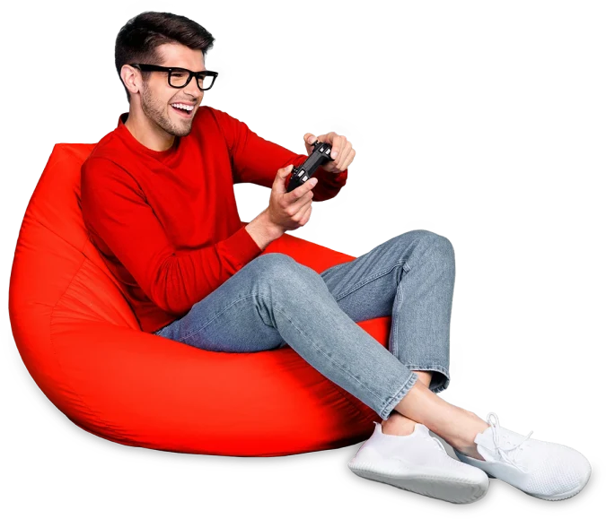 A man enjoying a video game while comfortably seated on a bean bag chair.