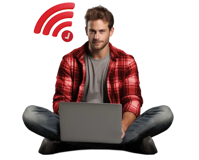 Laptop user on floor with wifi symbol in background.