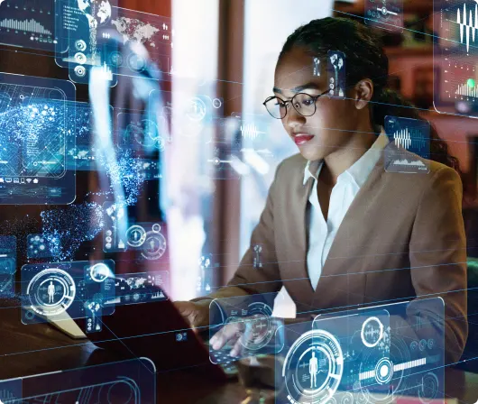 A professional woman in a business suit diligently working on her laptop.