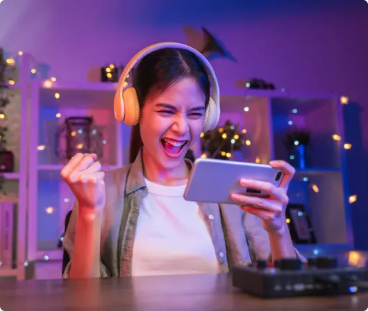 A girl wearing headphones and holding a phone