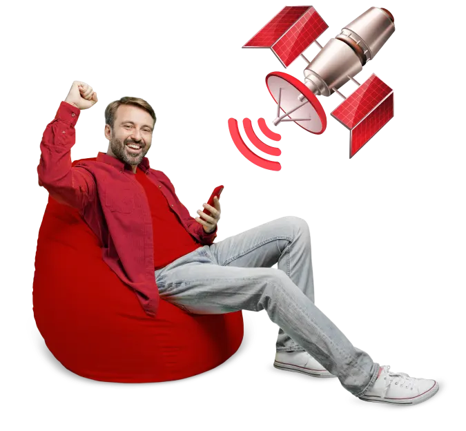 A man comfortably seated on a bean bag, using a satellite internet for communication.