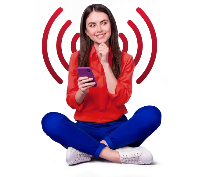 Woman using phone while sitting on floor.