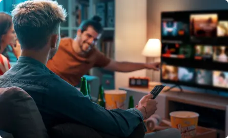 A group of people sitting on a couch watching television