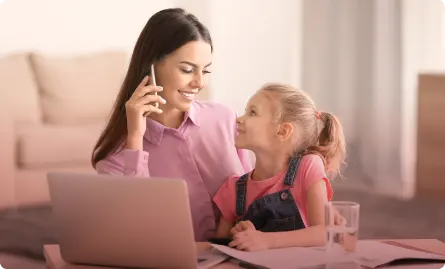 A woman and a child looking at a laptop