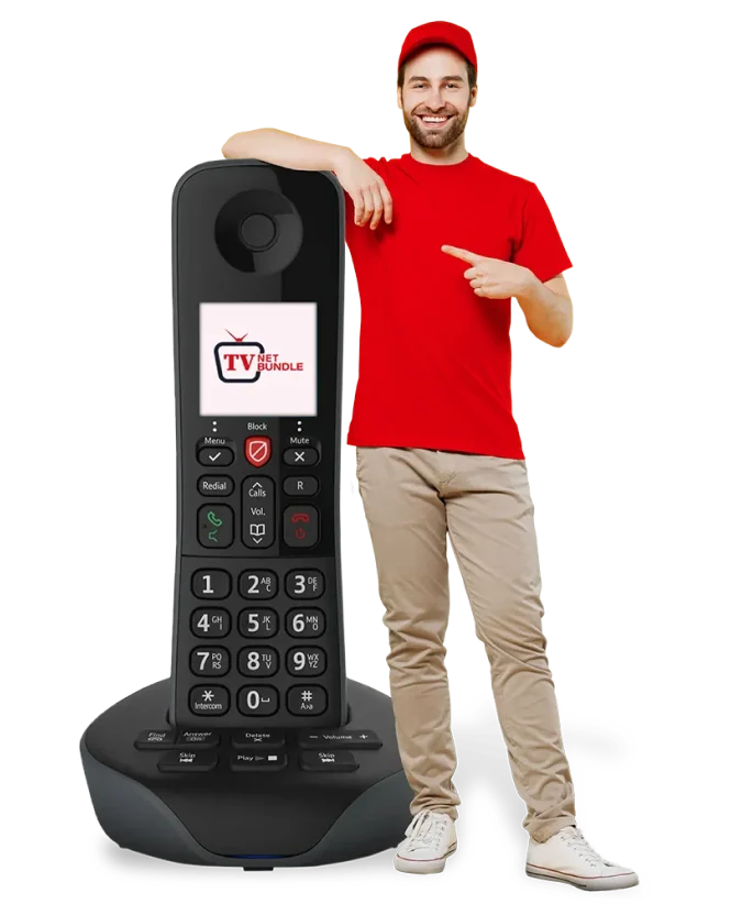 A man standing beside a massive phone, showcasing modern technology and communication.